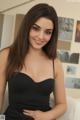 A woman in a black dress posing for a picture.